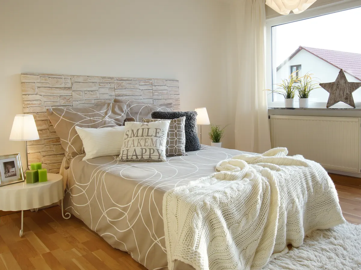 Schlafzimmer mit hellem Bett und Nachttischen